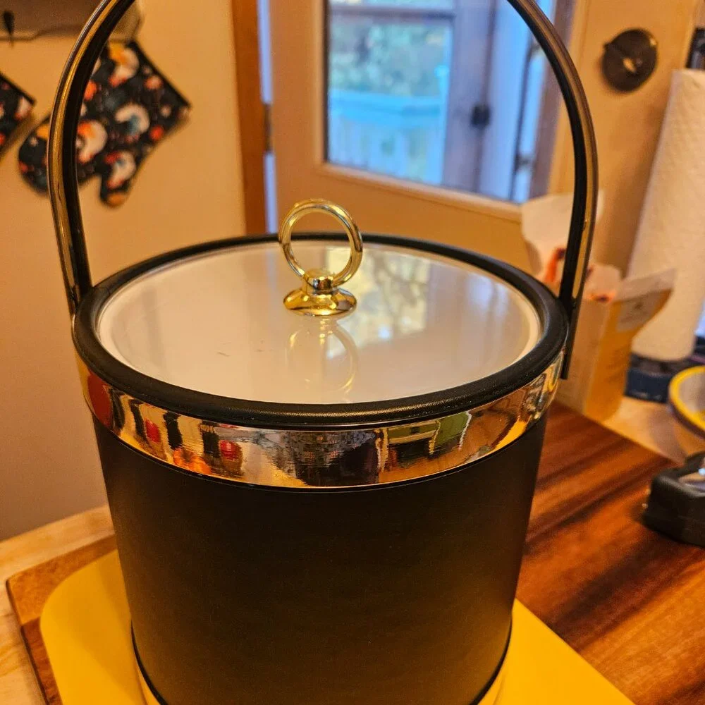 vintage ice bucket black with a sailboat design with a gold touch